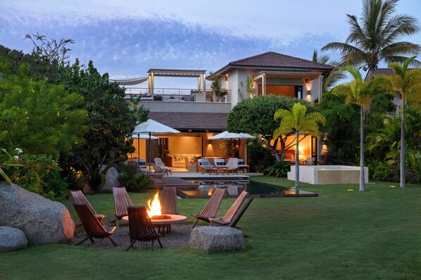 Private beachfront patio with lounge chairs and Fire pit