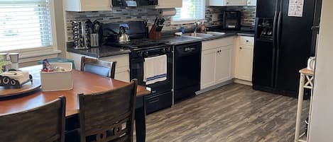 Fully stocked kitchen with dining area.