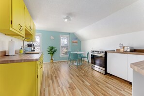 Kitchen is full of basic amenities, Toaster, oven, microwave, settings for 4.