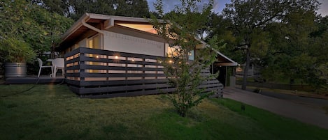 Exterior with large yard, wrap-around deck with and covered parking.