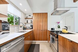 Galley style kitchen with custom walnut cabinetry