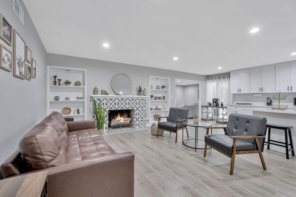 As you enter you are greeted with an open Living Room with Fireplace.