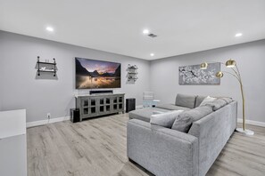 Family Room-Yep, that is an 82 inch HD TV w/ Netflix, Disney+, HBO MAX, & Prime