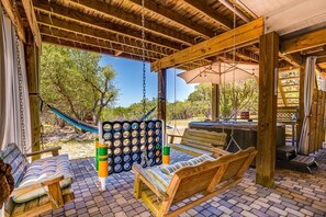 Tri porch swings underneath house with life size connect four.