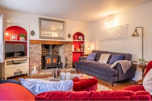 Homestead, Southrepps: Cosy sitting room with wood burning stove