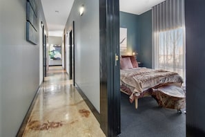 Beautiful polished floors. Hallway leads to bedrooms.  Master bedroom 2.  Queen bed.