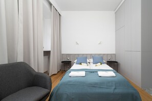 The elegant living area featuring a double bed and capacious wardrobe.