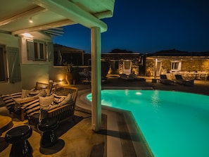 Outdoor sofa with table and view to the pool & sea