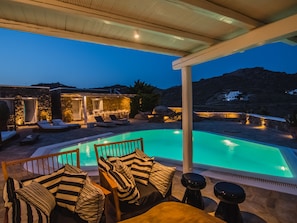 Outdoor sofa with table and view to the pool & sea