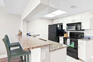 Cook with ease in this fully stocked kitchen with sleek granite counters