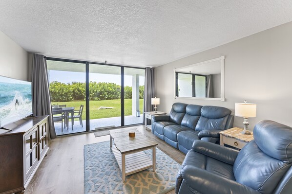 Relax in this stylish living room with a stunning view of the outdoors