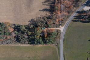 You will appreciate both the morning and afternoon sunlight that dances through the trees of this private setting, nestled in a small grove of trees surrounded by rural Leelanau County.