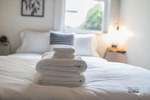 Comfortable bedroom with soft, luxurious linens and inviting decor, ideal for rest and relaxation.