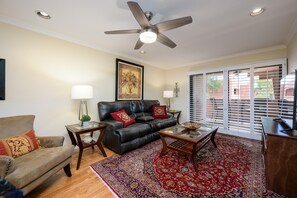 Living room has leather recliner couch.