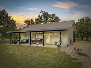 It's almost like an outdoor living room! Comfy furniture makes the shaded patio a relaxing gathering space.