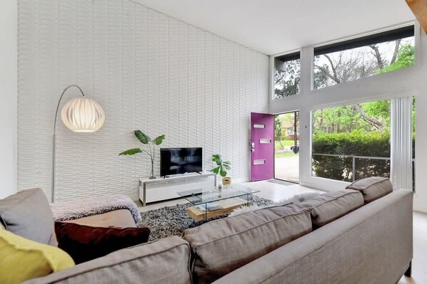 The living room features a comfy sectional sofa and ROKU TV