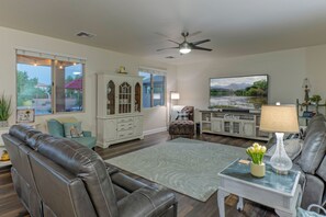 Elegant great room includes a cozy sitting area with comfortable seating and a large TV.