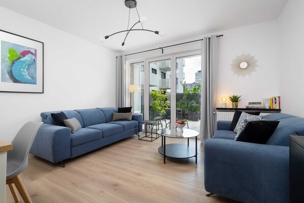 Relax in the stylish living room with comfortable sofas and modern decor.