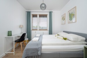 The cosy bedroom features a luxurious double bed and ample storage.