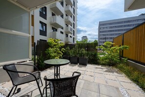 The terrace's stylish design complements the apartment's decor. 