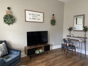 Large Smart TV with antenna and a desk for work space