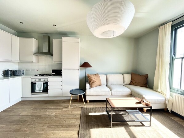 Open plan kitchen/living area with smart TV and double sofa bed (1)