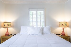 Slumber peacefully in one of four bedrooms at the cottage. This King Bedroom also has a tiny en-suite bathroom with a walk-in shower.