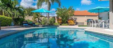Step out through sliding glass doors onto the newly updated pool deck where a sparkling heated pool awaits, surrounded by plenty of lounge chairs perfect for basking in the Florida sun.