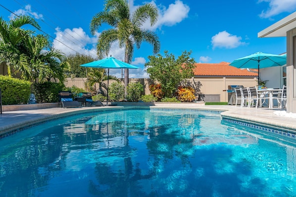 Step out through sliding glass doors onto the newly updated pool deck where a sparkling heated pool awaits, surrounded by plenty of lounge chairs perfect for basking in the Florida sun.
