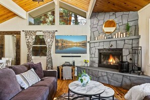 Living room featuring a wood burning fireplace, extra large wrap-around couch