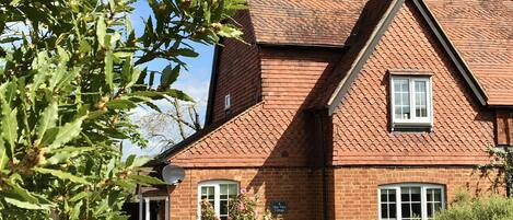 Charming Bay Tree Cottage built in 1895 with unusual tiled features.