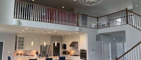 Two-story living room: gorgeous Foucault Chandelier & Bloomingdale’s furniture 