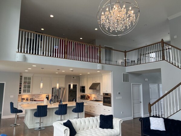 Two-story living room: gorgeous Foucault Chandelier & Bloomingdale’s furniture 