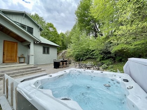 Hot tub, additional seating, and outdoor gas grill