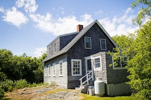 Back entry to the cottage with additional parking space.