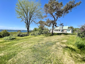 This spacious backyard is perfect for outdoor games or just sitting and enjoying the salty sea air.