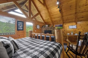 Bedroom with a king-sized bed, fireplace and a flat screen TV