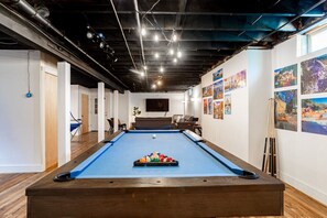 Game room and exercise equipment for use on lower level