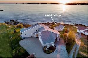 An aerial view showing the large main house and the cottage.