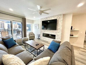 Living Area with 75" Smart TV. Balcony overlooking Maggie Pond and Ski Area