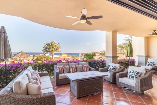 Covered patio w/ seating & ocean view