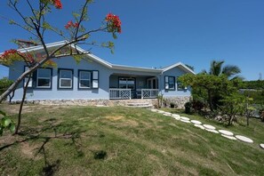 Scenic front yard with water views from 3 sides of this newly remodeled home