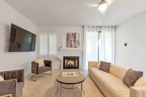 Living Room w/ Sofa, 2 chairs, wood fireplace & 70" Smart TV as you walk in the door