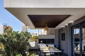 Outdoor dining area under a shaded pergola