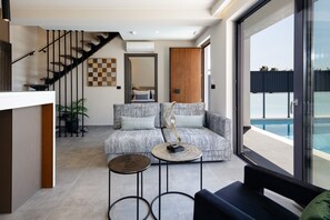 From the entrance of the villa is the open plan living room and kitchen with seating/living area.