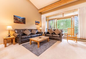 Living area featuring cozy furniture, a gas fire place, and a mounted TV.