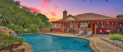 A dream backyard vibe featuring stone patio and pool.