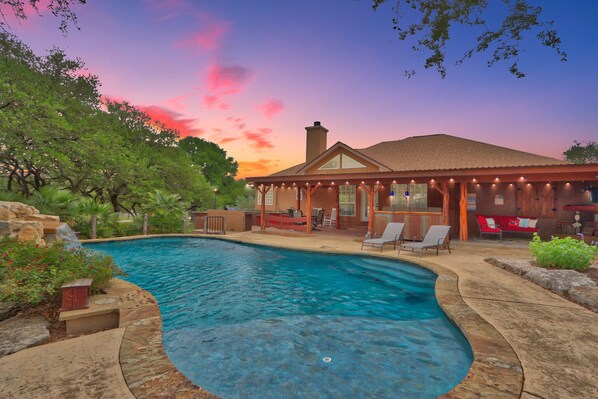 A dream backyard vibe featuring stone patio and pool.