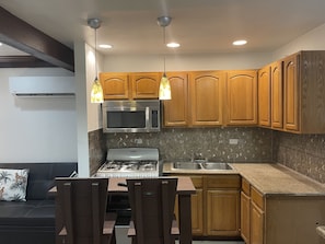 Newly renovated living, dining and kitchen with pool views!