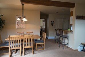 The charming dining area seats six and is just off of the kitchen and living areas. This angle highlights its close proximity to the kitchen, which provides additional seating for two more at the bar.